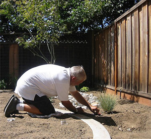 one of our Galveston irrigation installation techs is adding drip lines to the system